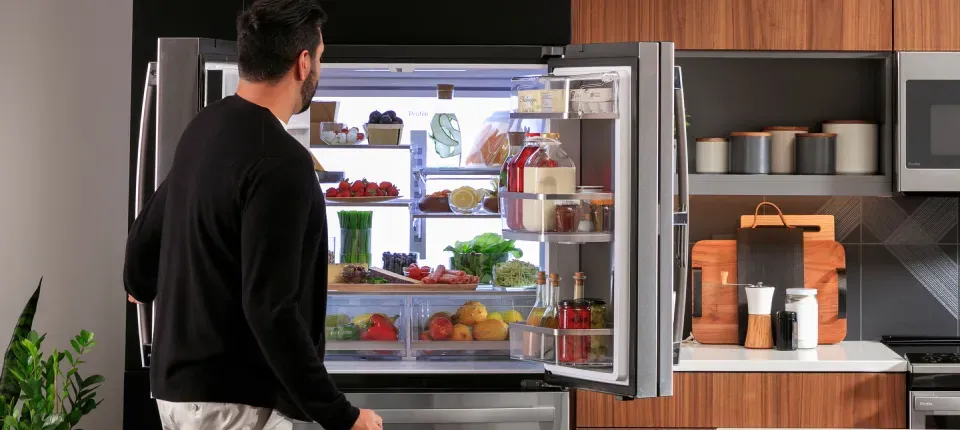 man looking into a new refrigerator